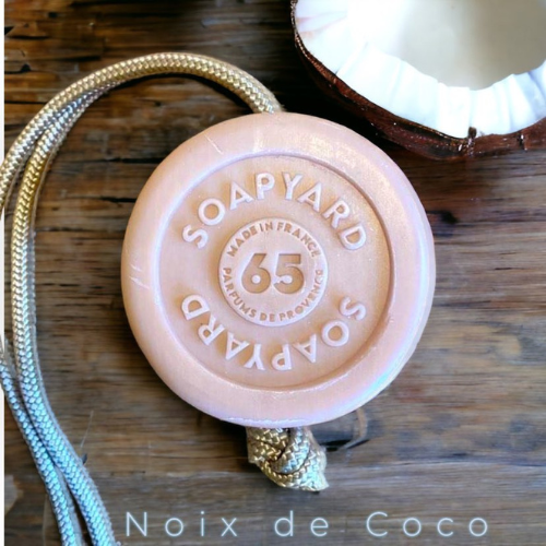coconut bar soap with organic shea butter on a rope on a natural background