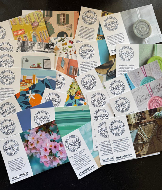 A flatlay of Soapyard soap brand promotional cards featuring colourful designs inspired by Provence and the Côte d’Azur, with the Soapyard logo and storytelling-style descriptions on each card.