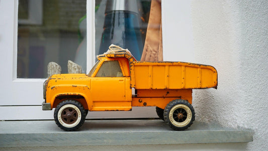 a vintage yellow tonka truck - the article is about beans and also mentions tonka beans