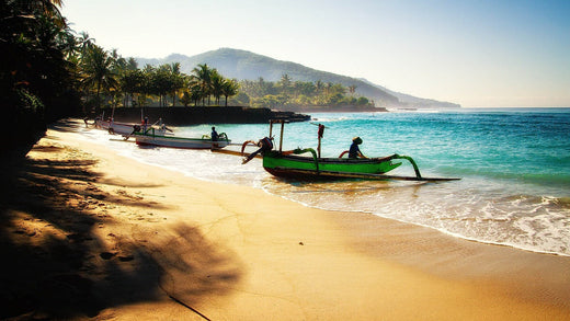 BEACH IN BALI WITH A FISHING BOAT. LOVELY BLUE SEA AND YELLOW SAND