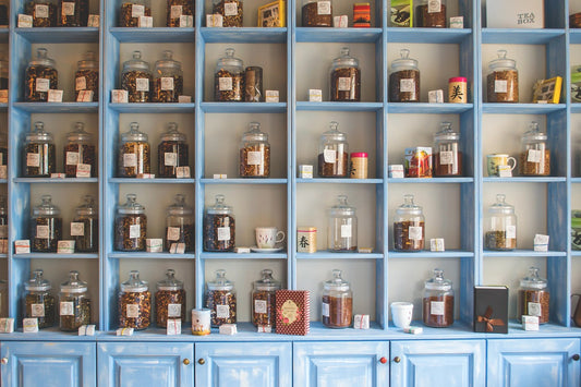 a shelf with lots of compartment with different teas in jars to show opportunities for entrepreneurs, home working, soap making, tea specialists