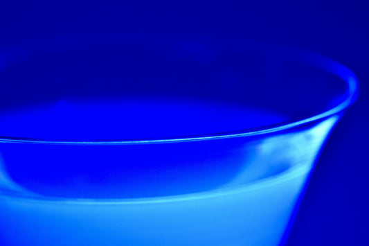 A close-up of a vibrant blue liquid in a glass container, symbolizing the striking color of methylene blue, a compound known for its medical and cognitive benefits.