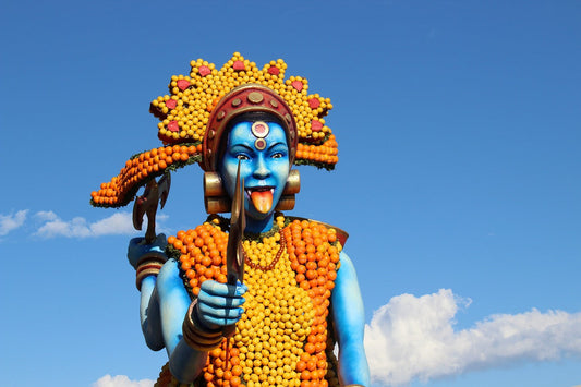 Menton Lemon Festival float of a blue statue with clothing and hat made of lemons, Menton lemons, Fête du Citron