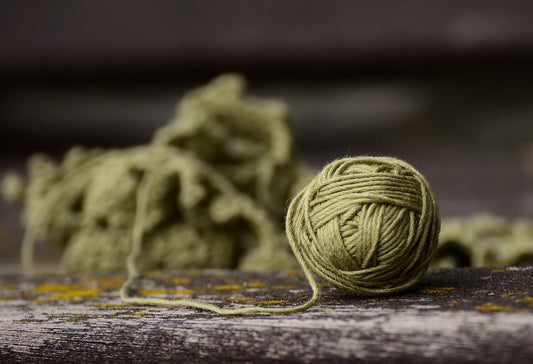 a ball of green yarn slightly unravelling